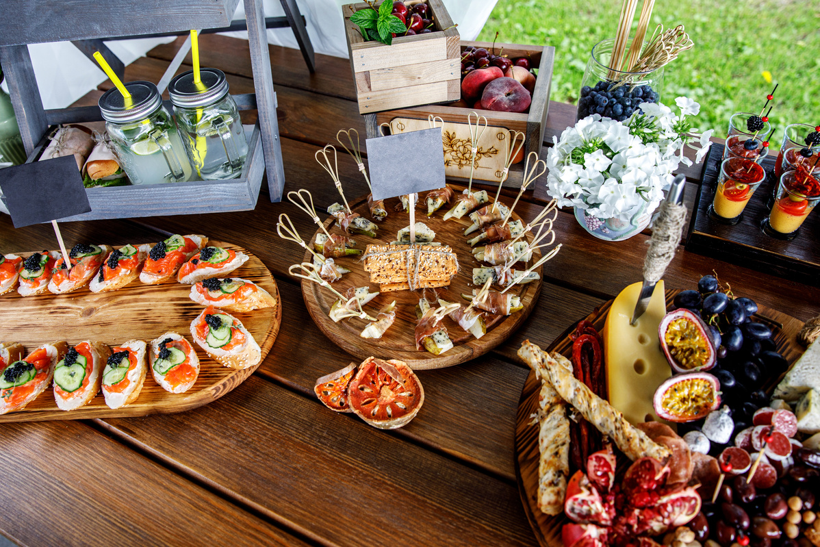 Summer party snacks on wooden table.