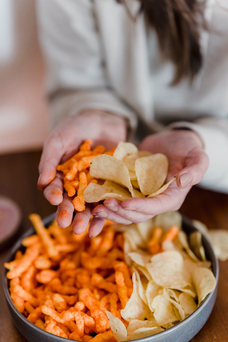 Female holding tasty snacks in hands